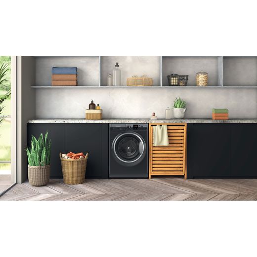 Hotpoint Anti-Stain NSWM 7469 BS UK 7kg Washing Machine with 1400 rpm - Black - Washing machine in utility room shot
